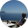 Man enjoys drink by ocean