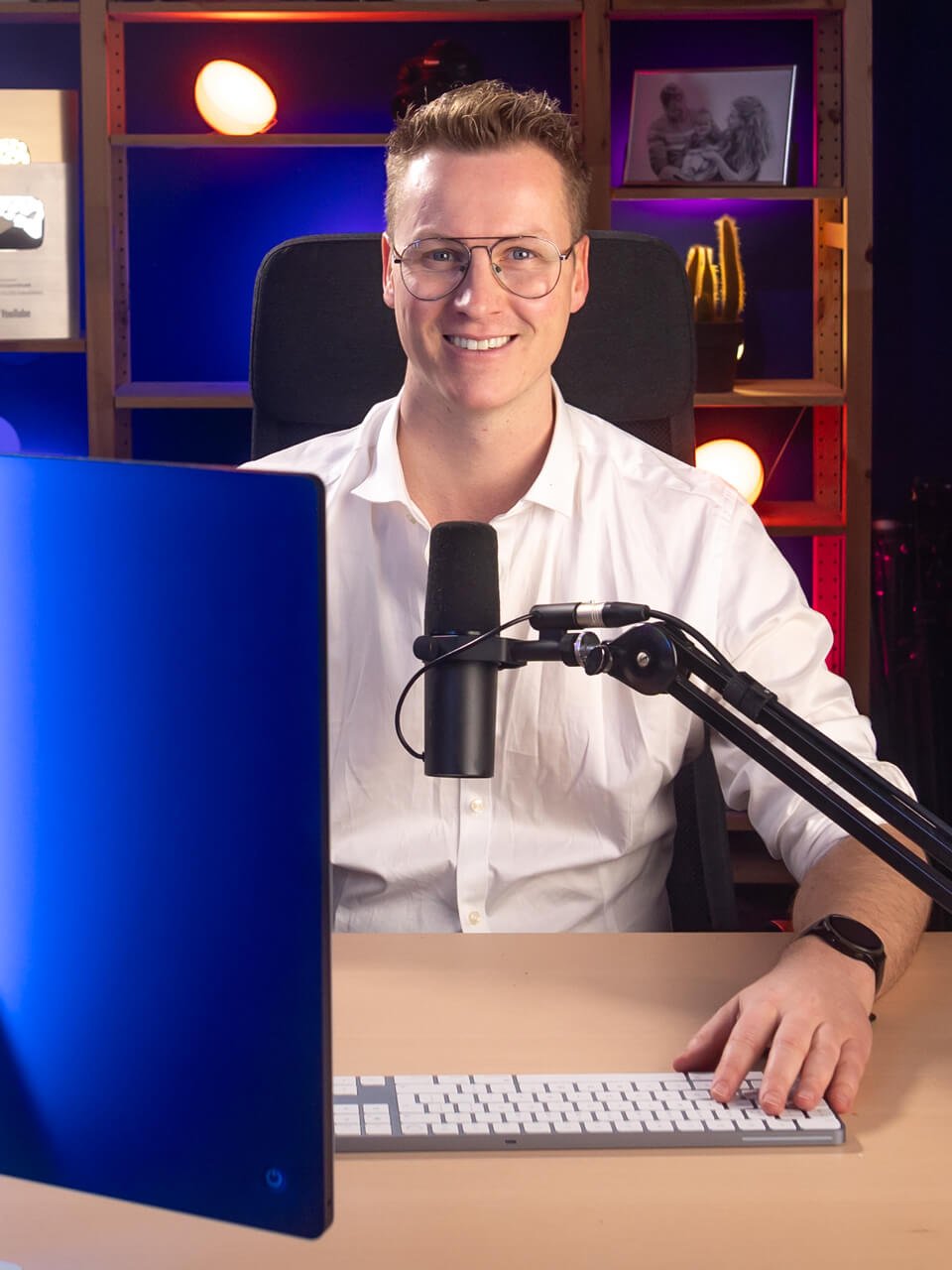 Man smiles at computer